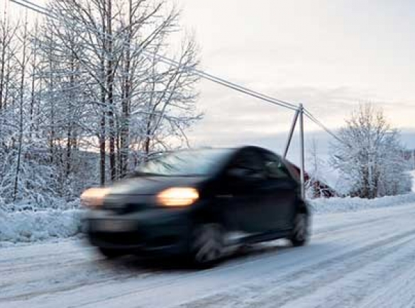 car moving down snowy road