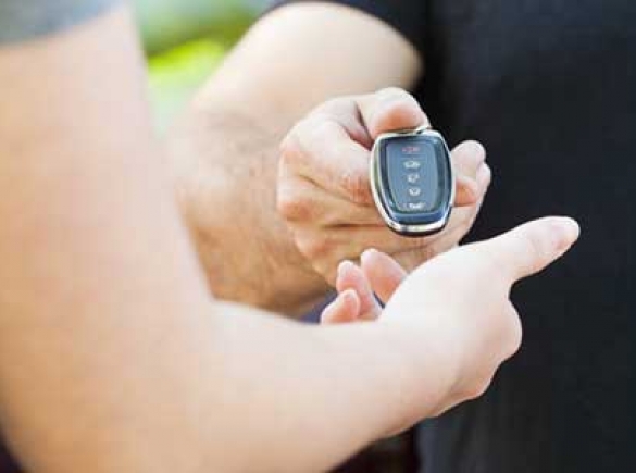 picture of hands of one person handing keys to another person