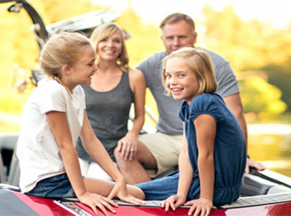 Happy family sitting on a boat