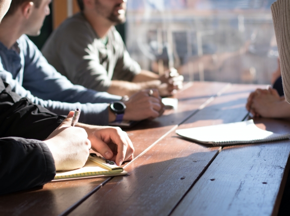 A group of coworkers gather at a table.