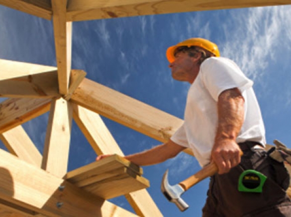 Man working on wooden structure construction 