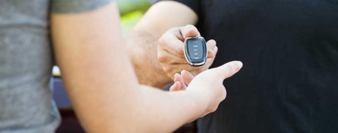 picture of hands of one person handing keys to another person