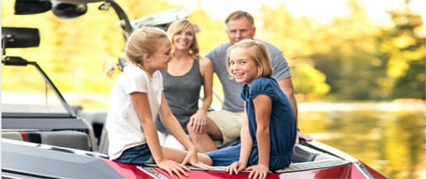 Happy family sitting on a boat