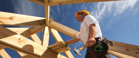 Man working on wooden structure construction 
