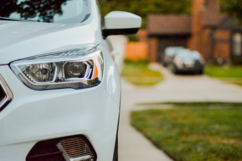 A white car parked in a driveway.